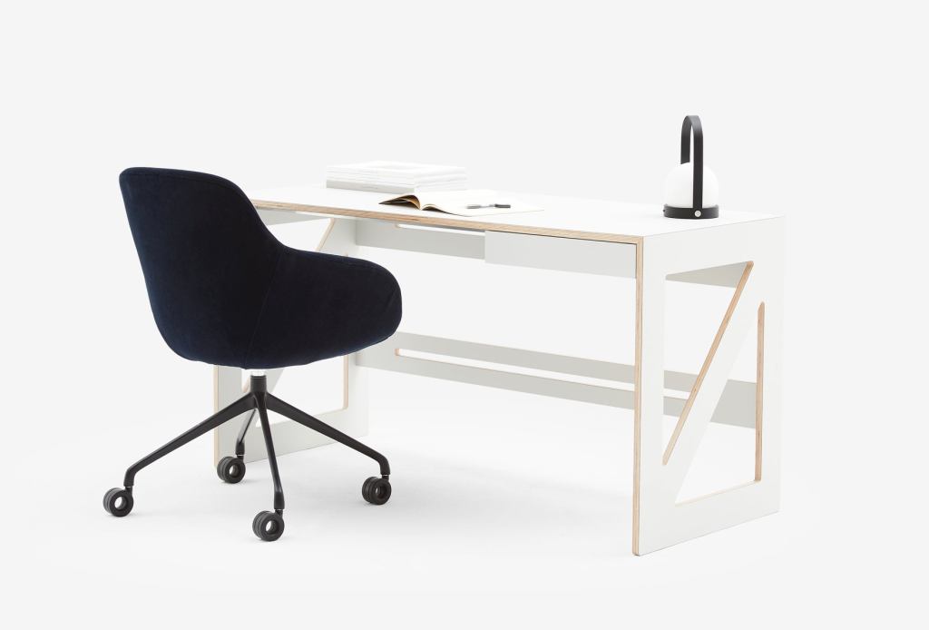 Otto Swivel Office Chair in navy blue paired with a modern white minimalist desk, creating a sleek and functional workspace.