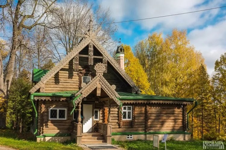 A traditional Russian Teremok-style wooden house at the Abramtsevo Art Colony, featuring intricate carved decorations and steep gabled roofs.