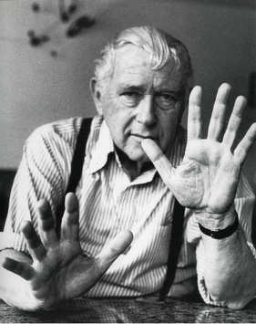 Black and white photograph of Marcel Breuer, showing him gesturing with his hands.