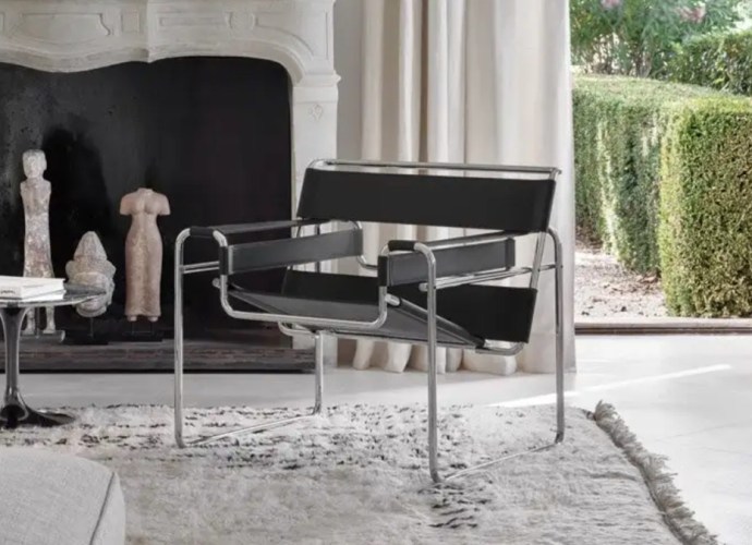 Wassily Chair by Marcel Breuer in a modern living room setting, featuring a chrome frame and black fabric seat.