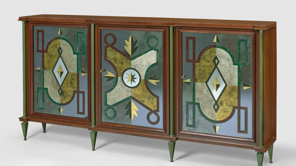 A rare mid-century modern sideboard by Jacques Klein, featuring geometric mirrored panels in gold, green, and blue tones, framed in rich wood and standing on green tapered legs.