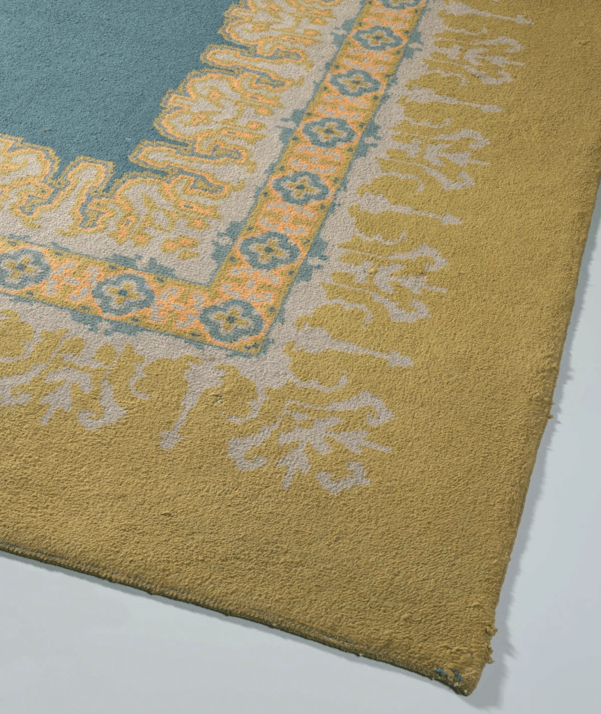 Knotted carpet, with a blue center and ornamental border designed by Theo Colenbrander