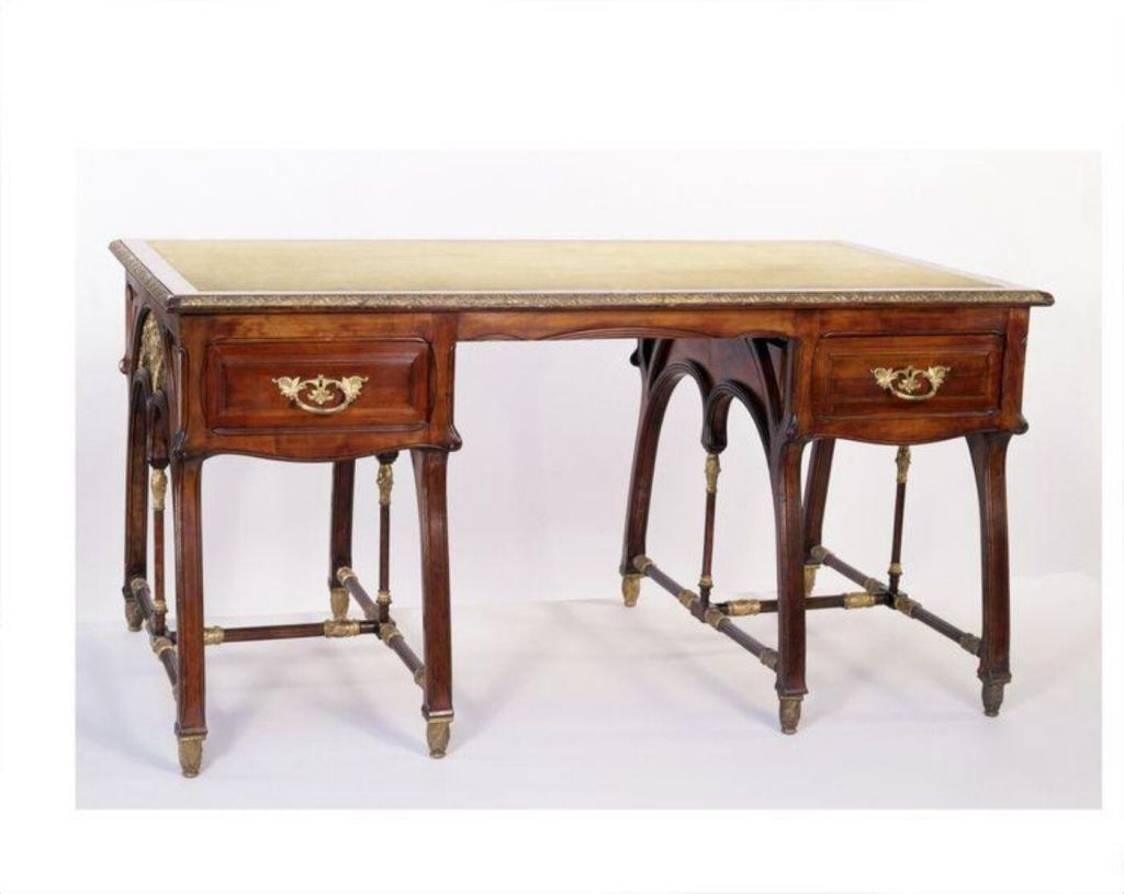 Writing table of carved and turned pearwood with mounts of gilt brass designed by Louis Bigaux