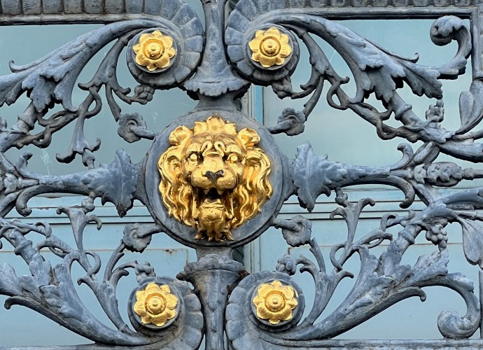 Gold coloured lion on gate