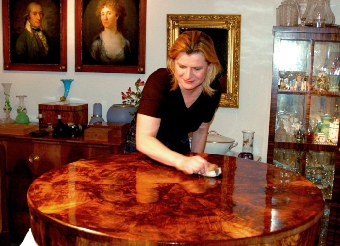 French Polishing an antique circular table.