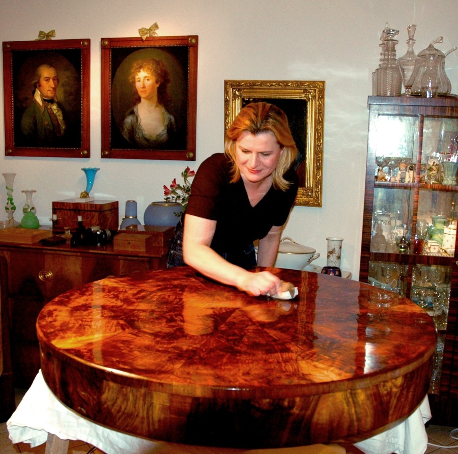 French Polishing an antique circular table.