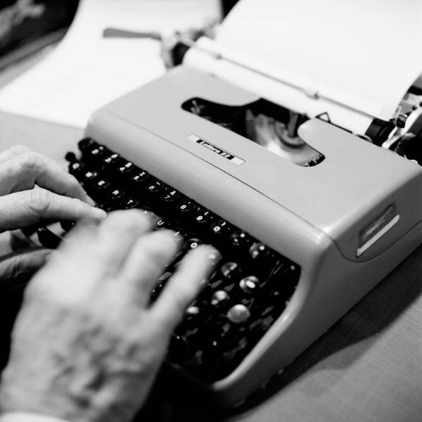 The hands of American writer, Gay Talese, typing on an Olivetti Lettera 22 typewriter
