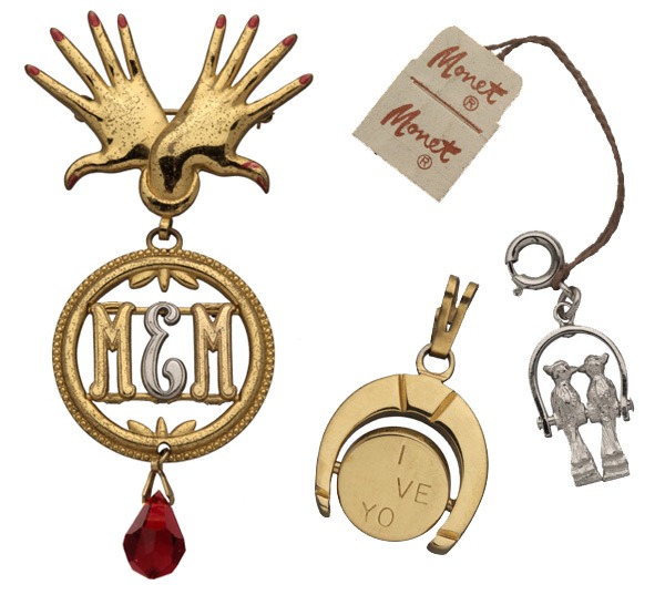 The dangle pin, from the mid-to-late 1930s, appears to bridge Monet’s monogramming roots and eventual prominence in the charms trade. The Monettes pieces are from 1959.