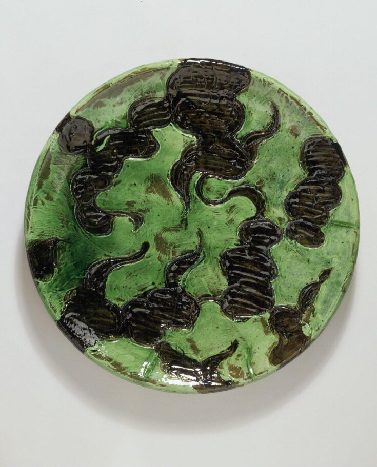Dish, earthenware, slip decorated and painted in green and brown, designed and decorated by Thorvald Bindesbøll, Denmark, 1936.