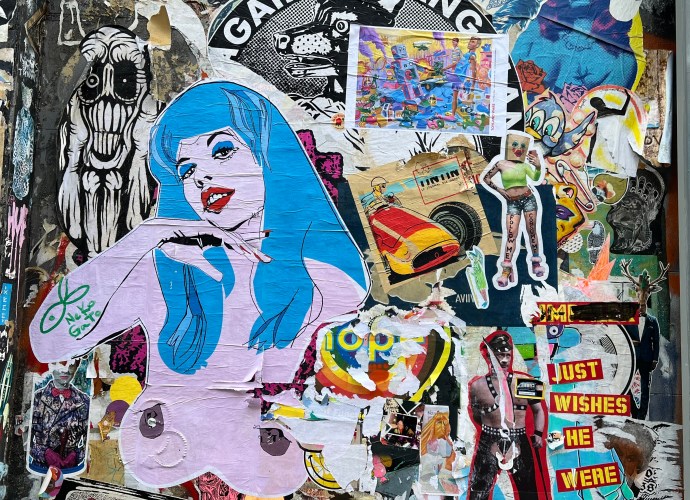 Eclectic collage of street art and pasted posters, characteristic of the Brick Lane area in London.