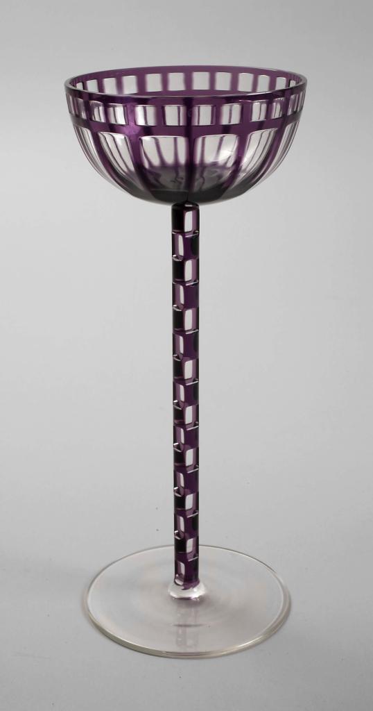 Detailed view of Otto Prutscher’s 1907 stem glass, showcasing intricate cube-cut stem and semi-spherical cup with geometric engravings.