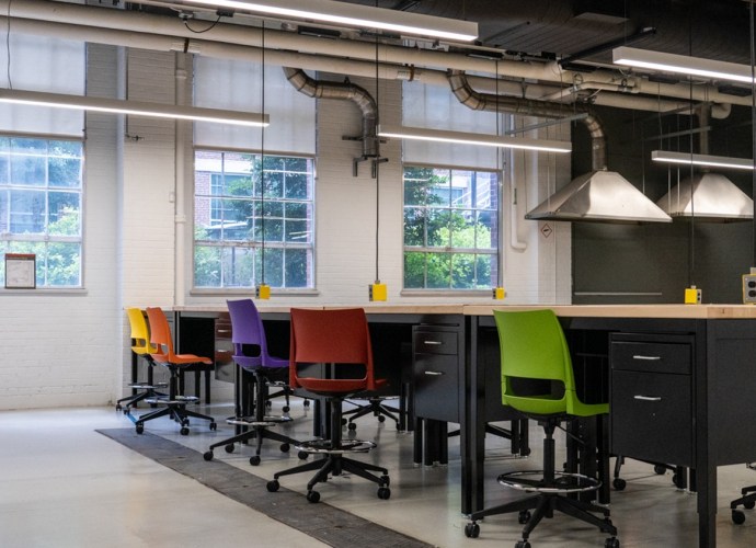 ndustrial Design classroom at NC State University featuring modern workstations, colorful chairs, and industrial lighting, fostering creativity and innovation.