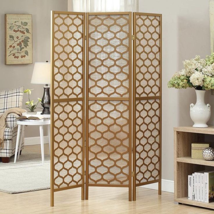 A decorative folding screen featuring vibrant floral patterns with intricate designs, framed by a wooden structure. The screen showcases traditional craftsmanship and artistic elegance.

