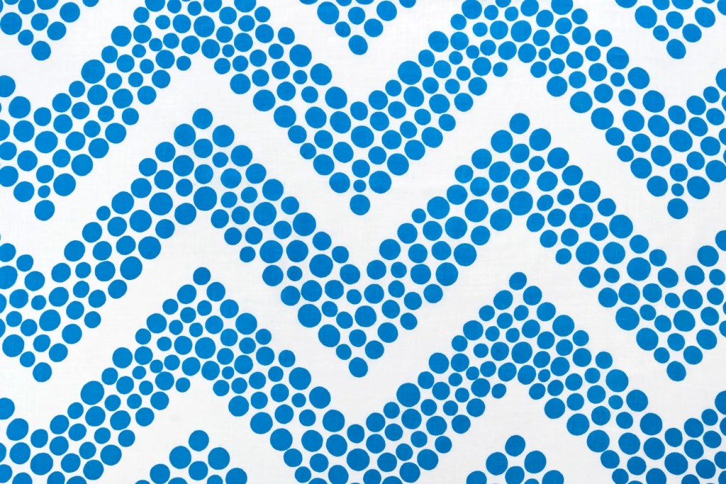 Kupla textile print featuring a blue herringbone pattern made of rising bubble-like dots on a white background, designed for the 2025 S/S collection.