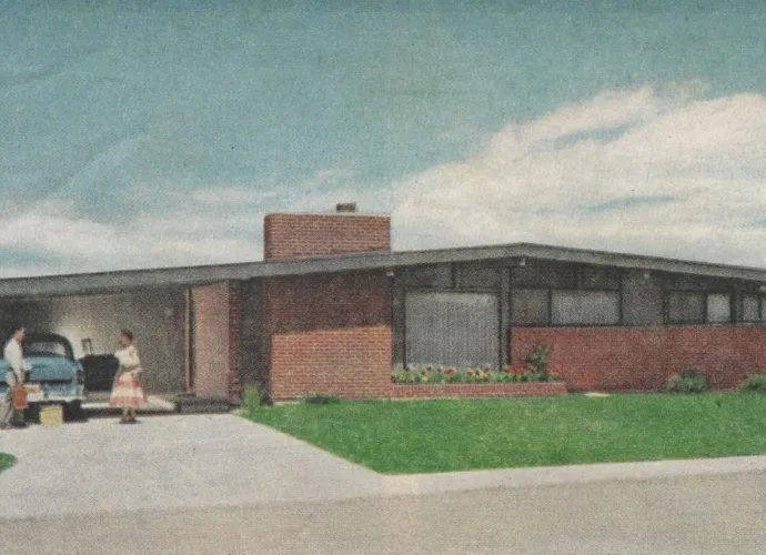 Mid-century modern home with low-pitched roof and brick-redwood exterior, featuring a double carport and minimalistic front landscaping