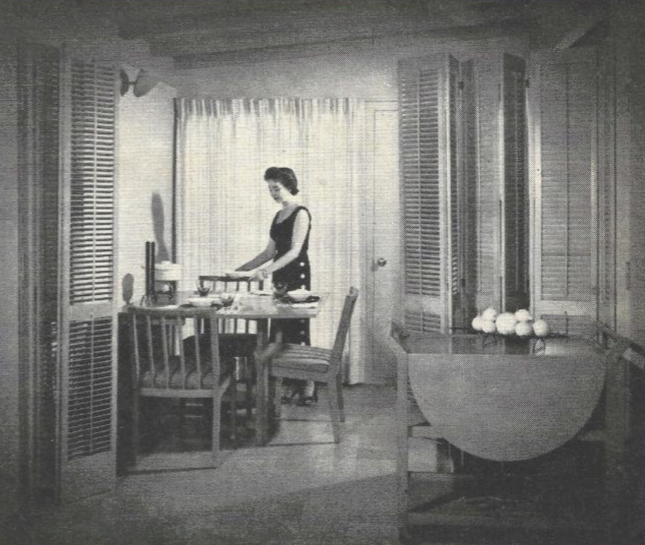 Mid-century dining room with folding shutters, cork flooring, and multifunctional layout in Household Home 601, with woman setting the table