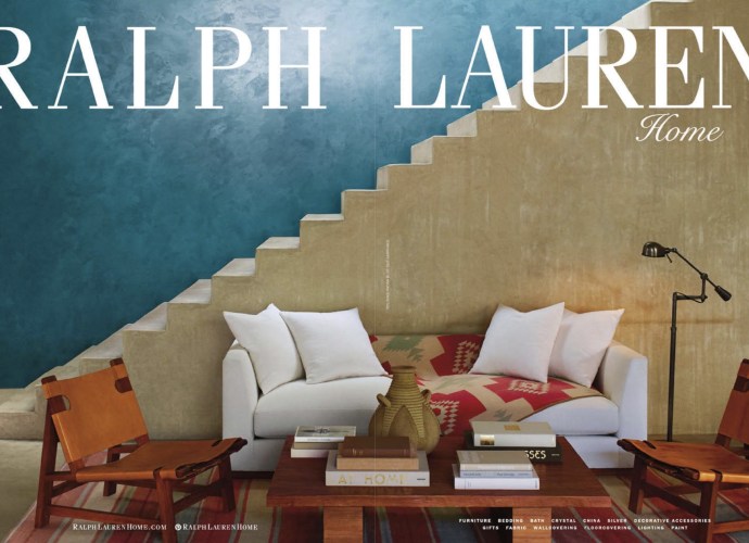 Ralph Lauren Home interior with Southwestern modern décor, featuring leather sling chairs, a white sofa with Navajo-style textile, and a stepped adobe staircase.