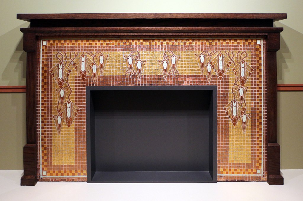 Prairie School fireplace designed by George Mann Niedecken with geometric mosaic tiles and stylised organic motifs