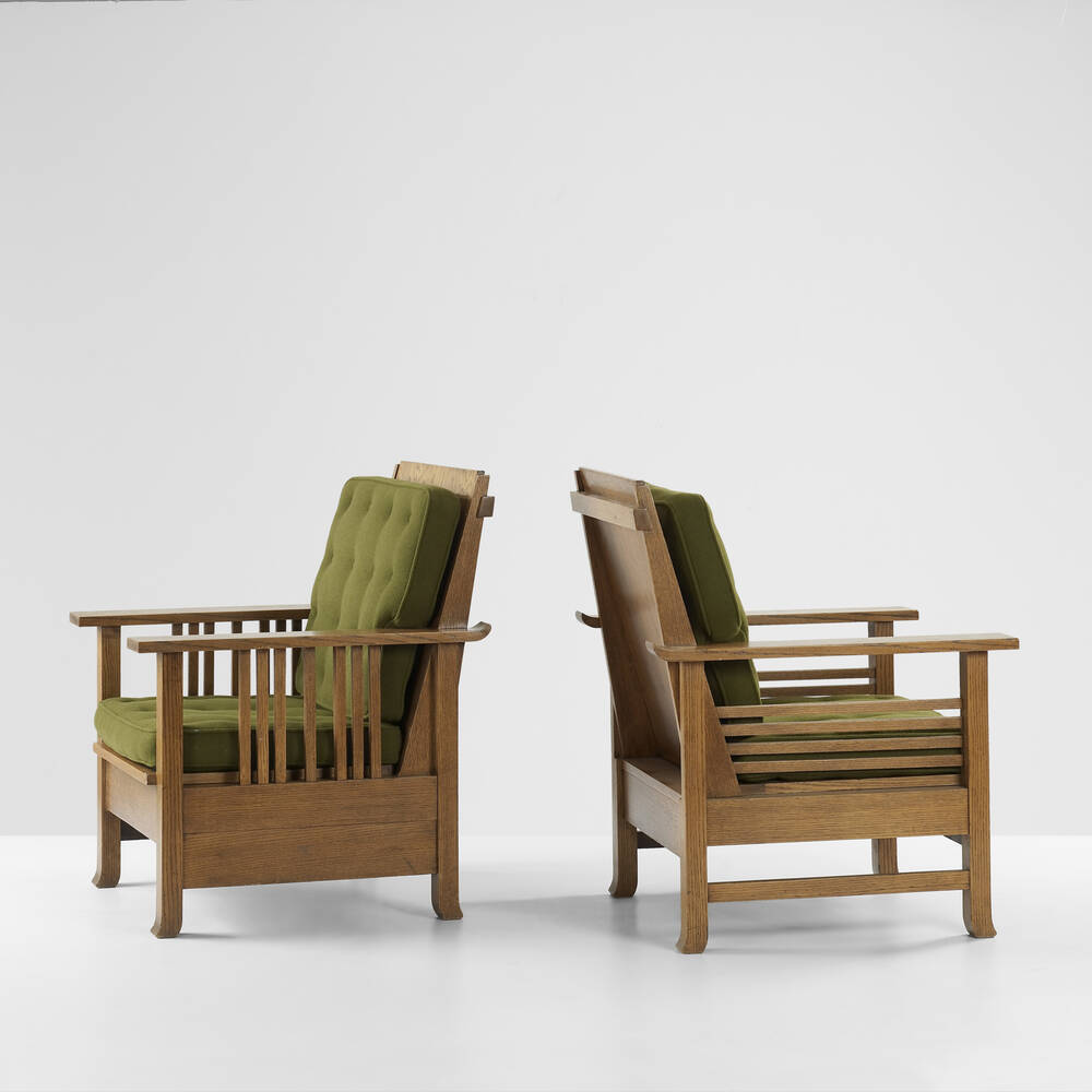 Pair of Prairie School armchairs by George Mann Niedecken and Frank Lloyd Wright with geometric oak frames and green upholstered cushions